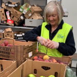 Volunteer sorting through food 